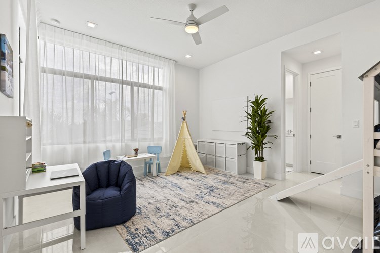 A living room with a blue chair, a white table, and a rug.