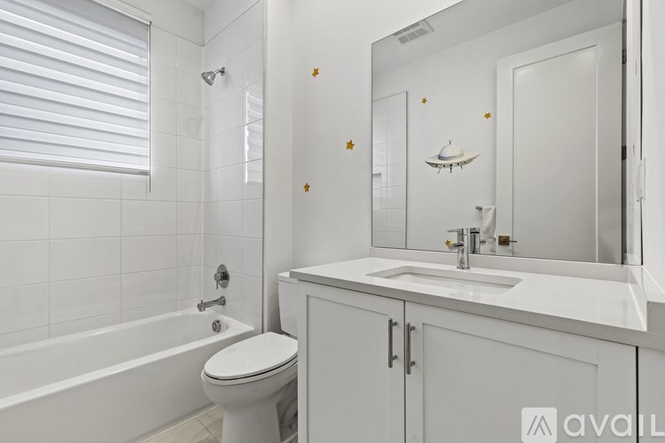 A white bathroom with a toilet, sink, and bathtub.
