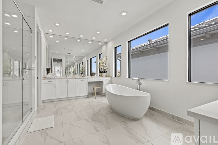 A modern bathroom with a large tub and a walk-in shower.