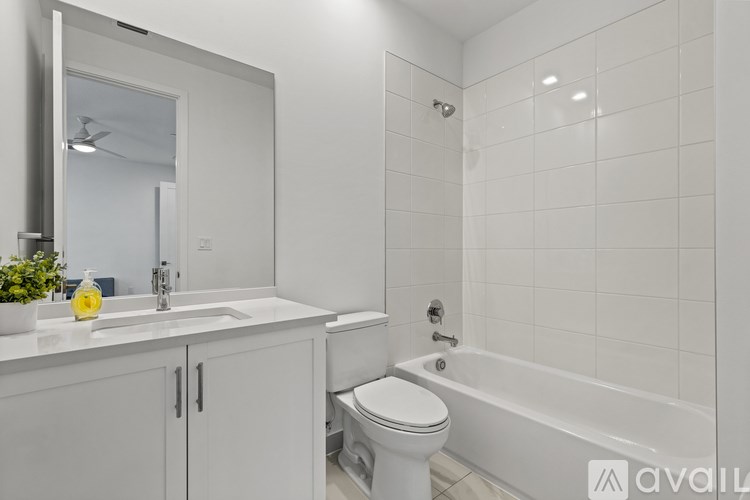 A white bathroom with a toilet, sink, and bathtub.