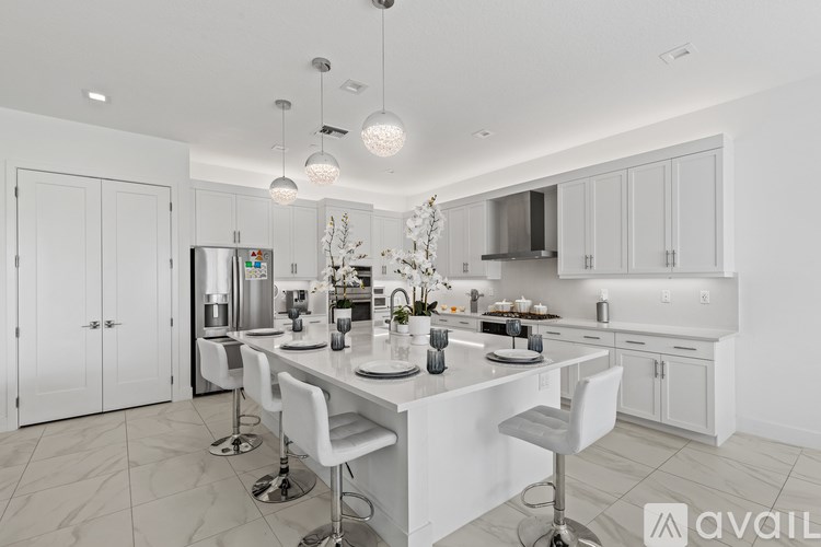 A modern kitchen with white cabinets and a central island.