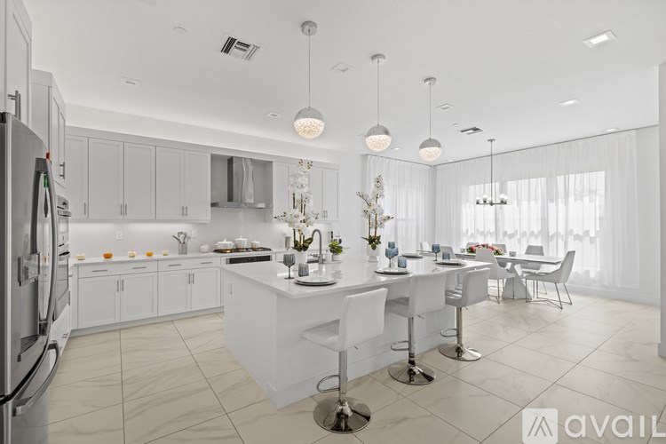 A modern kitchen with white cabinets and a large island.
