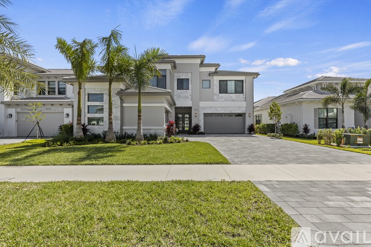 A row of houses with a driveway in front.