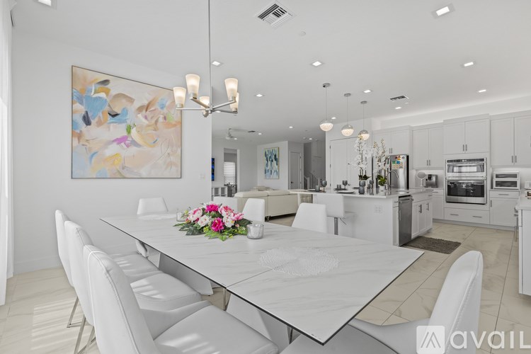 A modern kitchen with a dining table set for four.