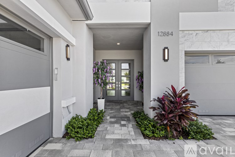 A modern house entrance with a number 12884 on the wall.