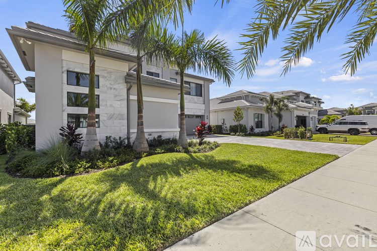 A row of houses with palm trees in front.