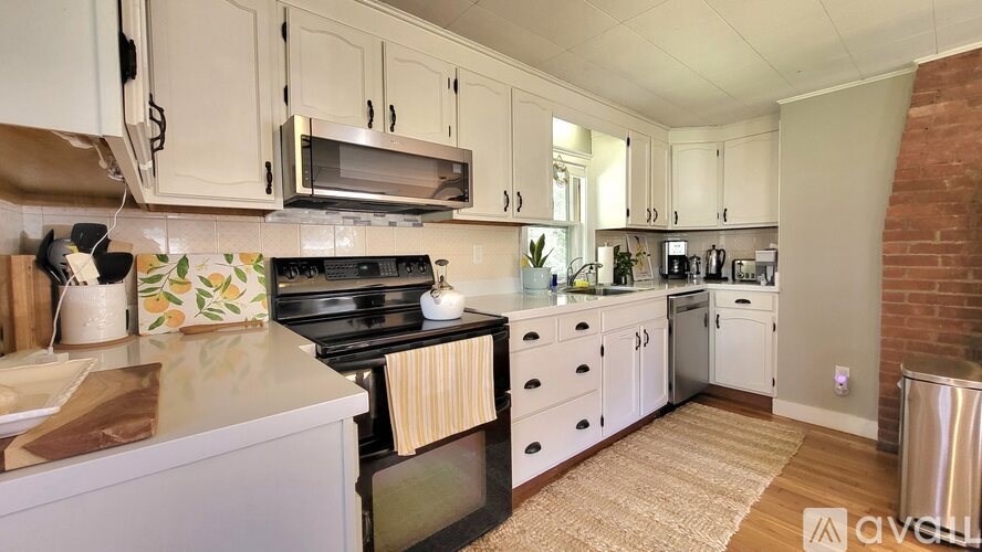 A kitchen with a stove top oven and a microwave above it.