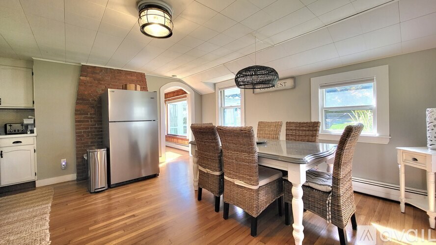 A kitchen with a table and chairs in the middle of the room.