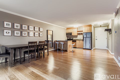 A kitchen with a dining table and chairs.