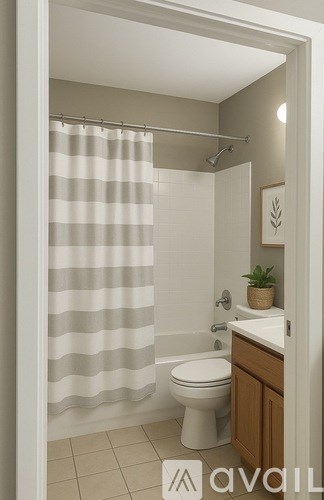A bathroom with a toilet, sink, and shower curtain.