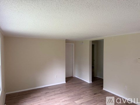 A kitchen with white cabinets and appliances.