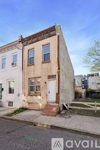 A white house with a brown door and windows.