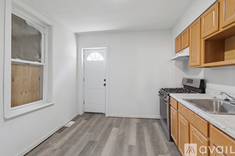 A kitchen with wooden cabinets and a white door.
