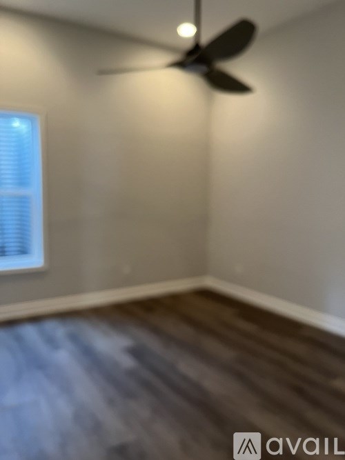 A room with a fan and a window.