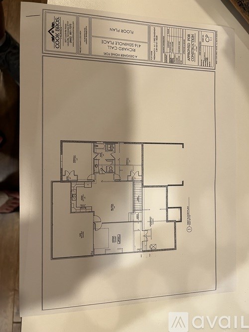 A floor plan of a building with a staircase and multiple rooms.