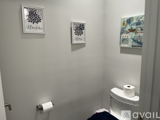 A bathroom with a toilet paper roll on the holder.