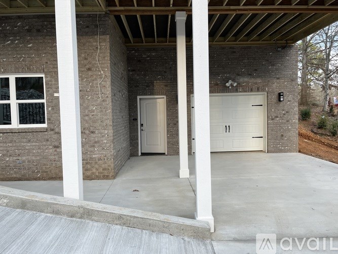 A garage with a white door and a window is available for rent.