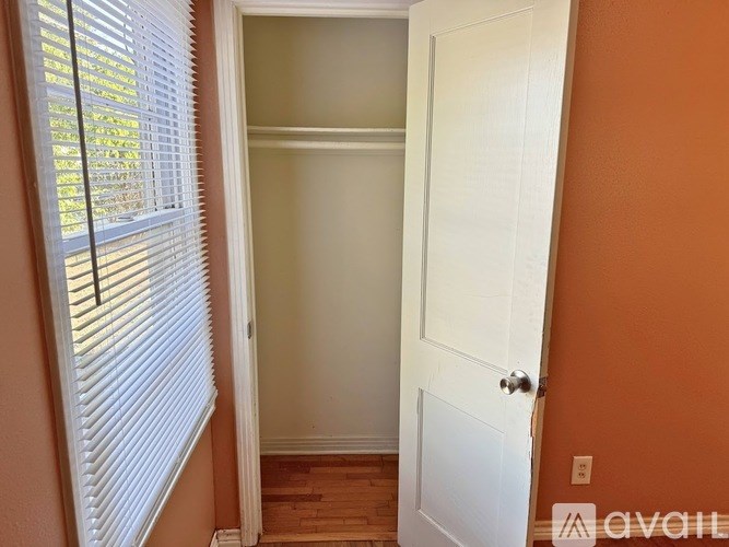 A white door is in a room with a brown wall.
