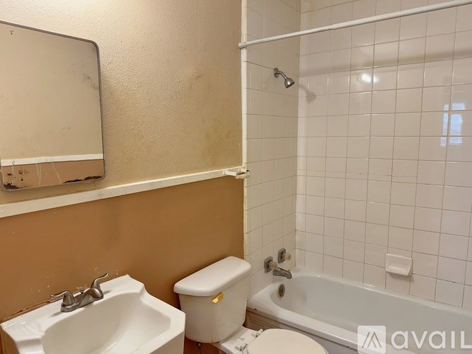 A bathroom with a sink, toilet, and bathtub.