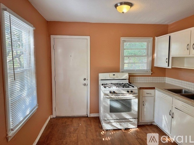 A kitchen with a stove and cabinets.