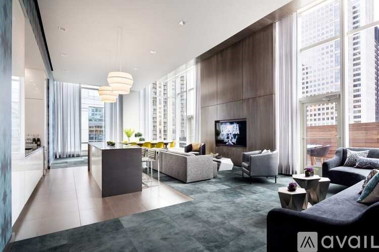 A modern living room with a large couch and a television.