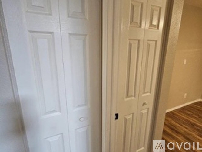 A white door with a black handle is on the left and a white door with a silver handle is on the right.