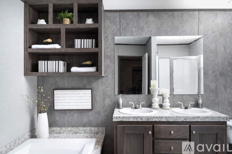 A bathroom with a marble countertop and a white bathtub.