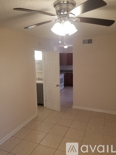 A room with a ceiling fan and a light fixture.