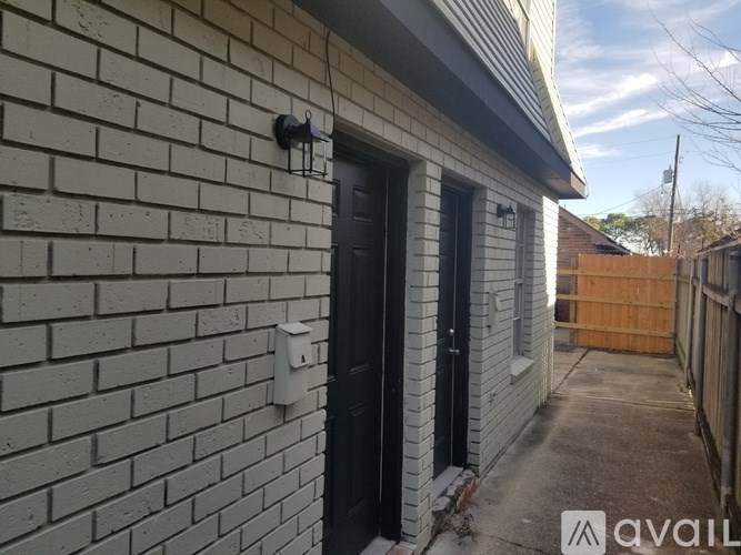 A house with a black door and a white wall.