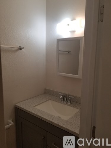A bathroom with a sink and mirror.