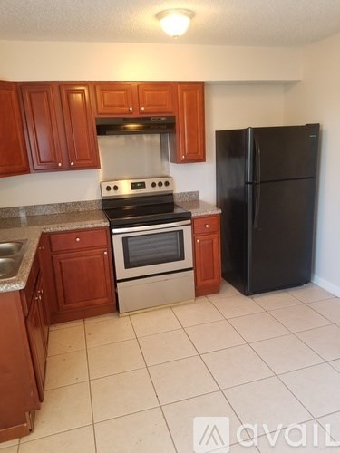 A kitchen with a black refrigerator, stove, and oven.