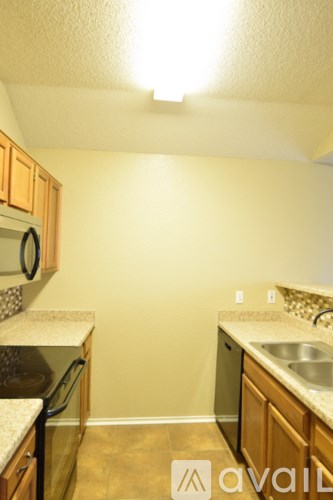 A kitchen with a sink and a refrigerator.