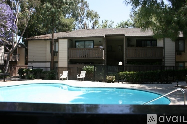 A pool in front of a building with a sign that says "available".