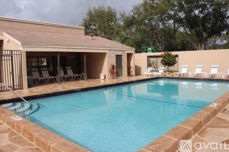 A pool with a house in the background.