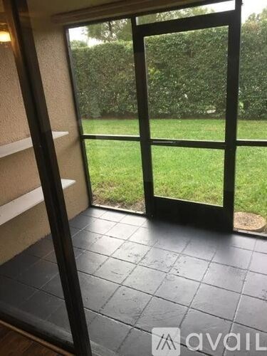 A glass door leading to a green lawn.