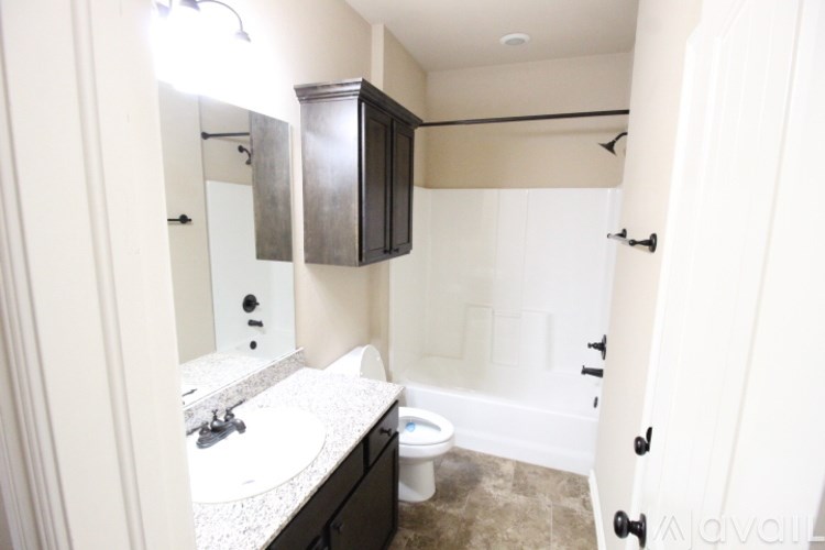 A bathroom with a sink, toilet and shower.