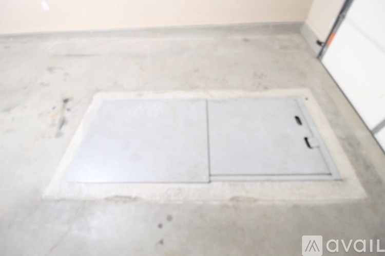 A white door in a room with a dirty floor.