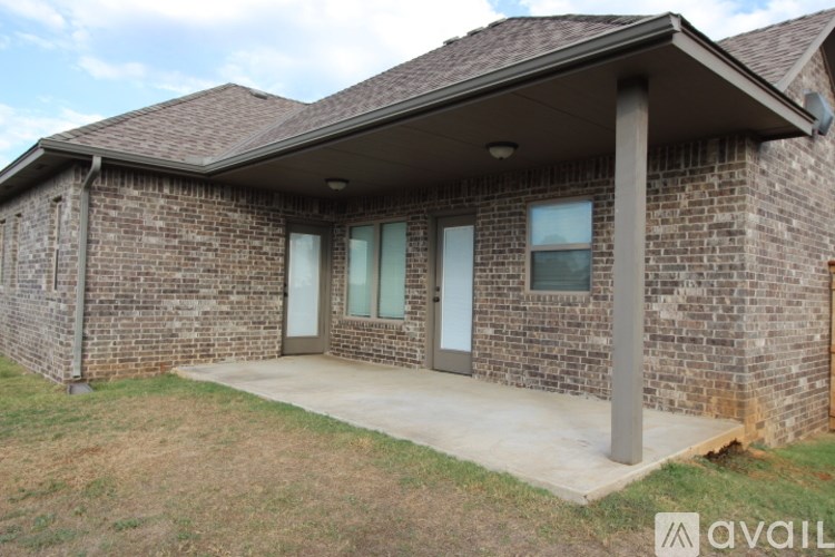 A brick house with a porch and a covered entrance.