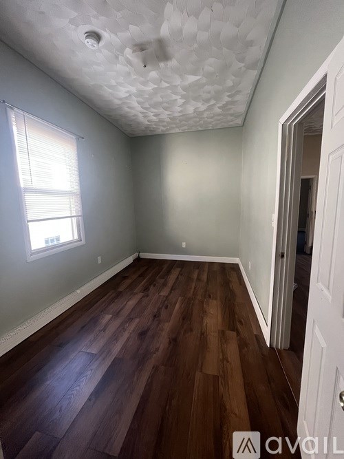 A room with a white door, a vanity table with a mirror, and a collection of green and pink balls on the floor.