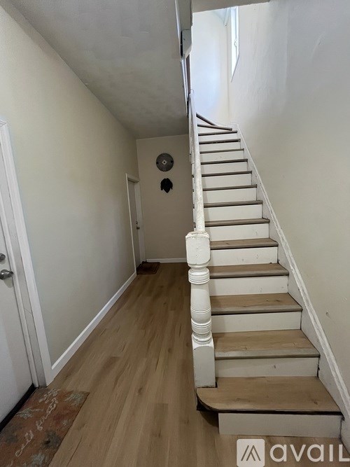 A staircase with white railings and wooden steps.
