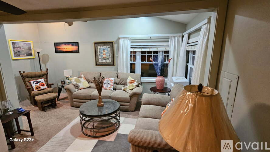 A living room with a couch, armchair, and coffee table.