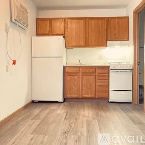 A kitchen with wooden cabinets and white appliances.
