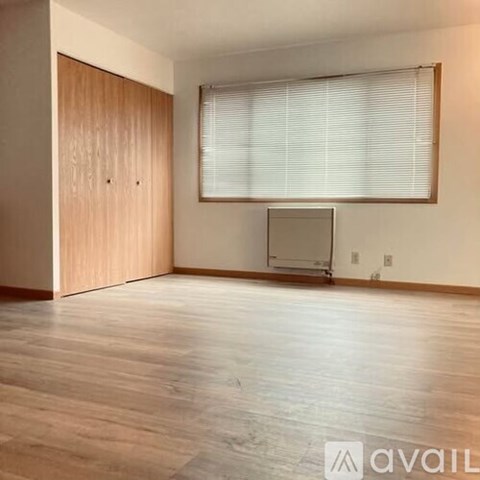 A room with wooden floors and a television set.