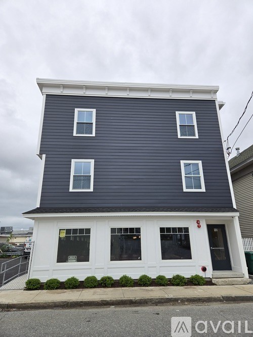 A two-story house with a blue exterior and white trim.