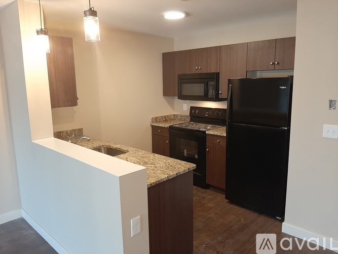 A kitchen with white cabinets and a black stove top oven.