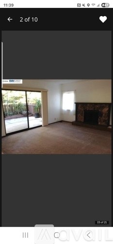 A room with a fireplace and a sliding glass door.