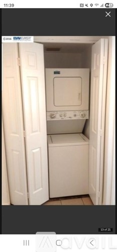 A white oven is built into a cabinet.