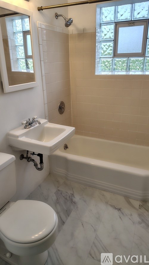 A white toilet is next to a sink in a bathroom.