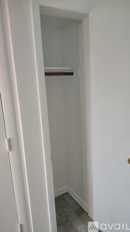 A white door with a handle and a small white square on the side.