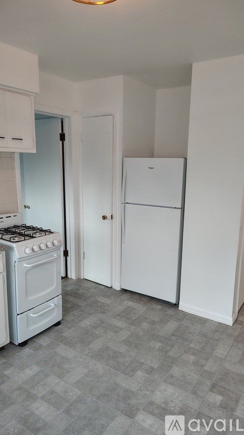 A small kitchen with a white fridge and a white stove.